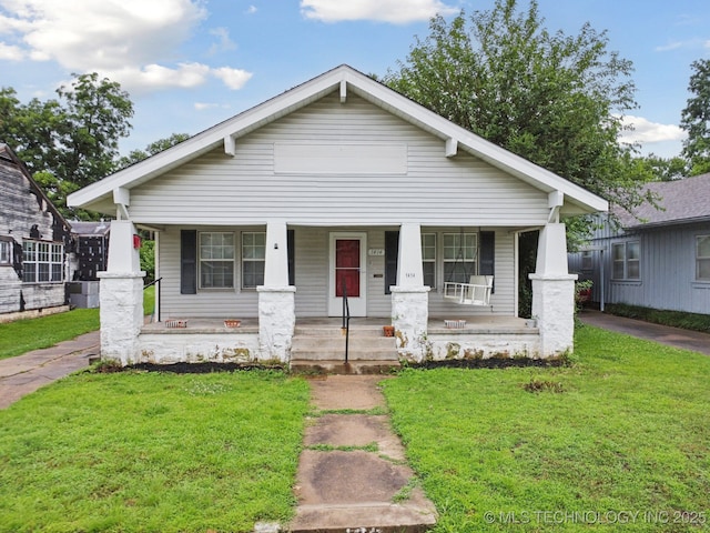 1414 E 8th St, Okmulgee, OK 74447 - view of front of home featuring a porch and a front lawn