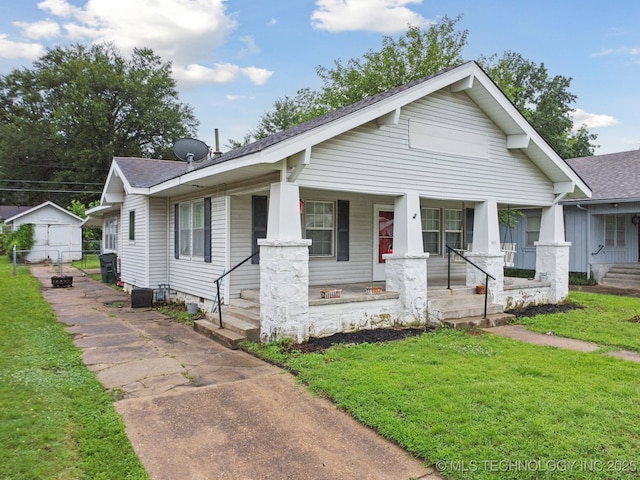 1414 E 8th St, Okmulgee, OK 74447 - bungalow-style home with a shingled roof and covered porch