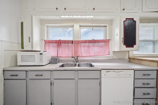 1414 E 8th St, Okmulgee, OK 74447 - kitchen featuring white appliances, white cabinets, and healthy amount of natural light