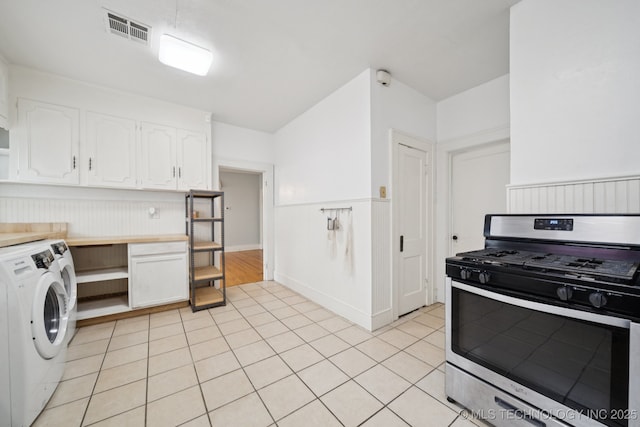 1414 E 8th St, Okmulgee, OK 74447 - kitchen featuring stainless steel range with gas cooktop, washer / dryer, white cabinetry, open shelves, and light tile patterned floors