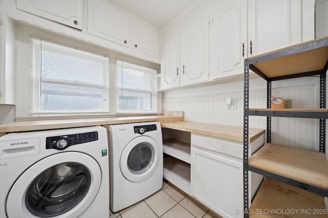 1414 E 8th St, Okmulgee, OK 74447 - laundry room with washer and dryer, cabinet space, and light tile patterned flooring