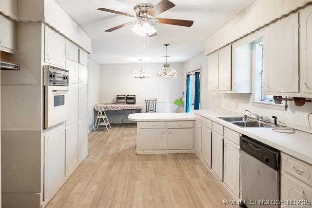 528 Stephens Rd, Eufaula, OK 74432 - kitchen with stainless steel dishwasher, white oven, a peninsula, light wood-style flooring, and a ceiling fan