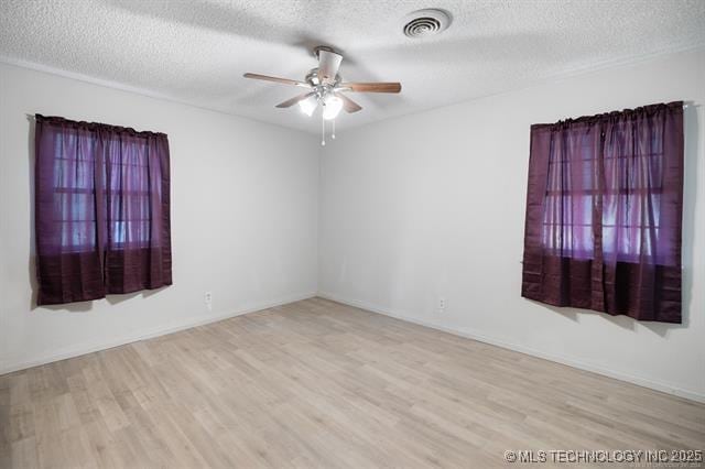 528 Stephens Rd, Eufaula, OK 74432 - unfurnished room featuring wood finished floors, ceiling fan, and a textured ceiling