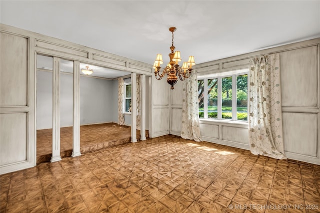 9916 S Quebec Ave, Tulsa, OK 74137 - unfurnished dining area featuring a decorative wall and a chandelier