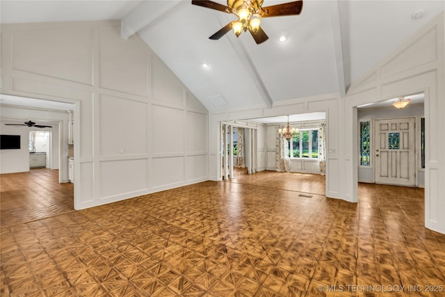 9916 S Quebec Ave, Tulsa, OK 74137 - unfurnished living room featuring a decorative wall, ceiling fan, a chandelier, beamed ceiling, and high vaulted ceiling