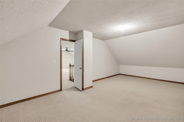 9916 S Quebec Ave, Tulsa, OK 74137 - additional living space featuring lofted ceiling, light carpet, and a textured ceiling