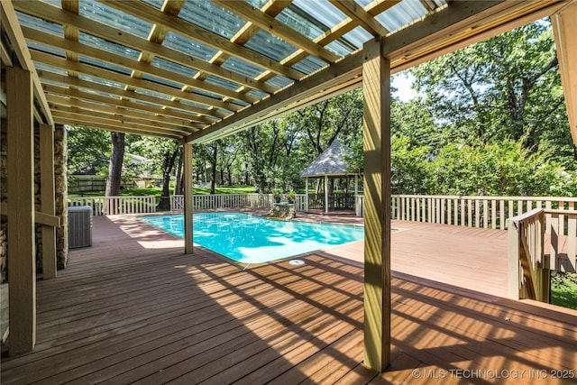 9916 S Quebec Ave, Tulsa, OK 74137 - view of pool with a gazebo, a wooden deck, and view of scattered trees