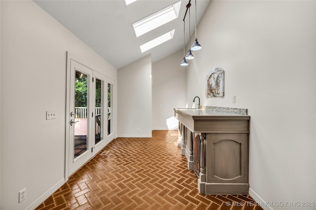 9916 S Quebec Ave, Tulsa, OK 74137 - hall featuring lofted ceiling, brick patterned flooring, and a skylight