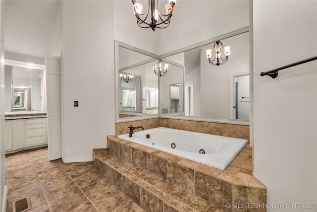 9916 S Quebec Ave, Tulsa, OK 74137 - bathroom featuring a chandelier, a whirlpool tub, vanity, and a high ceiling