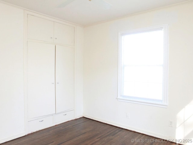 4957 S Cincinnati Ave, Tulsa, OK 74105 - unfurnished bedroom featuring dark wood-style flooring, a closet, and ceiling fan