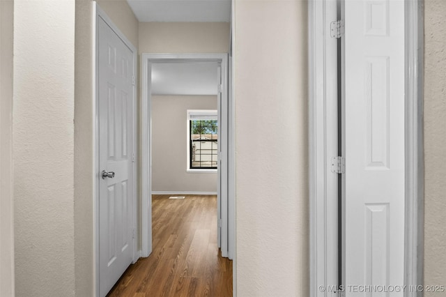 8903 N 124th E Ave, Owasso, OK 74055 - hall featuring dark wood-type flooring and a textured wall