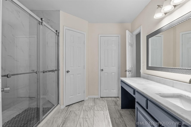 8903 N 124th E Ave, Owasso, OK 74055 - bathroom with a marble finish shower, vanity, and marble look tile flooring