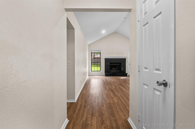 8903 N 124th E Ave, Owasso, OK 74055 - hall with dark wood-style flooring, lofted ceiling, and a textured wall