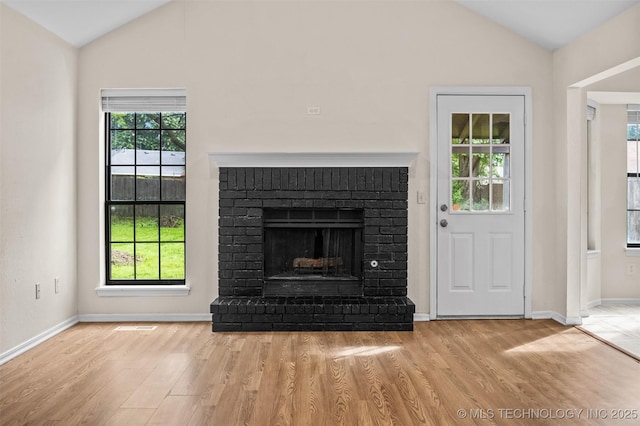 8903 N 124th E Ave, Owasso, OK 74055 - unfurnished living room with lofted ceiling, wood finished floors, and a fireplace