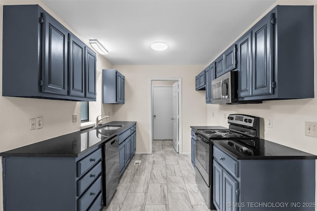 8903 N 124th E Ave, Owasso, OK 74055 - kitchen featuring stainless steel appliances, light marble finish flooring, dark countertops, and blue cabinetry