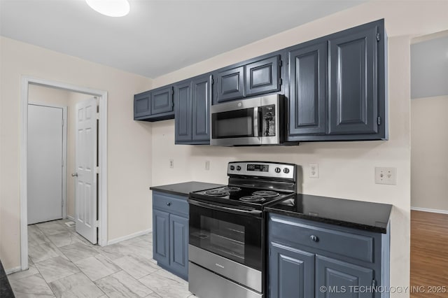 8903 N 124th E Ave, Owasso, OK 74055 - kitchen with appliances with stainless steel finishes, dark countertops, and light marble finish flooring