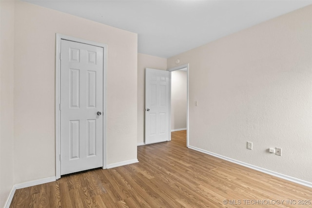 8903 N 124th E Ave, Owasso, OK 74055 - unfurnished bedroom featuring wood finished floors