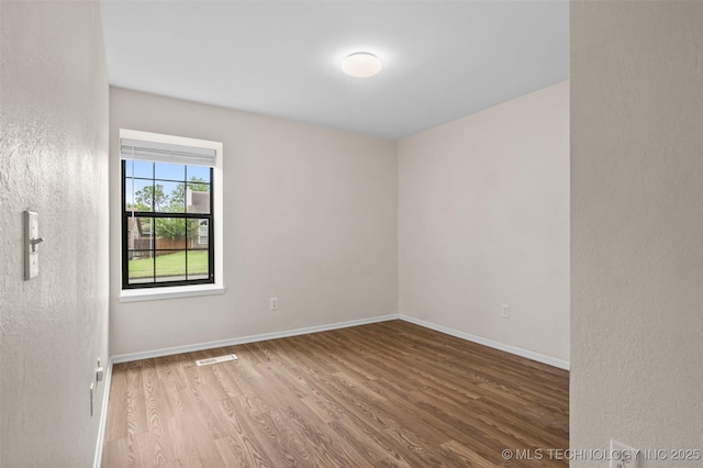 8903 N 124th E Ave, Owasso, OK 74055 - empty room featuring wood finished floors and baseboards