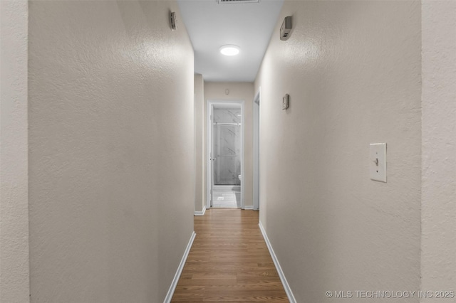 8903 N 124th E Ave, Owasso, OK 74055 - hallway with dark wood-type flooring and a textured wall