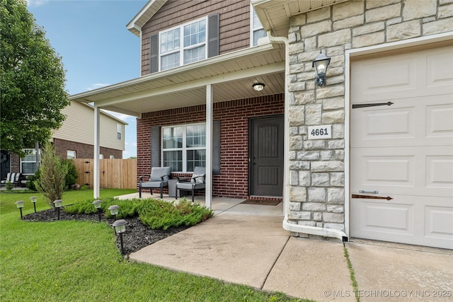 4661 E 148th St S, Bixby, OK 74008 - entrance to property featuring stone siding, a porch, and a garage