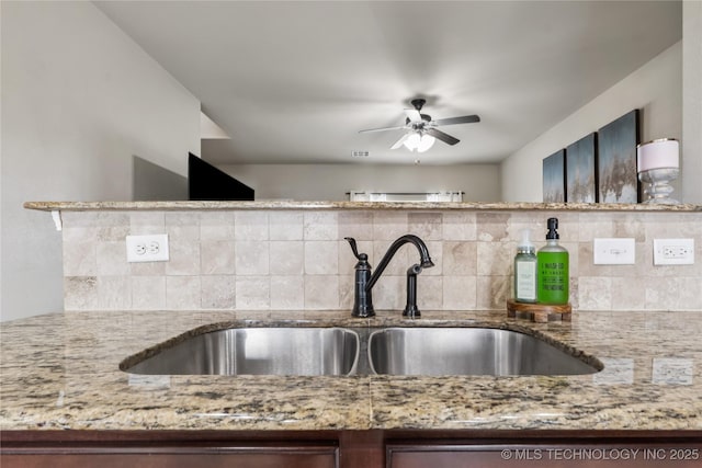 4661 E 148th St S, Bixby, OK 74008 - kitchen with light stone counters, backsplash, and ceiling fan
