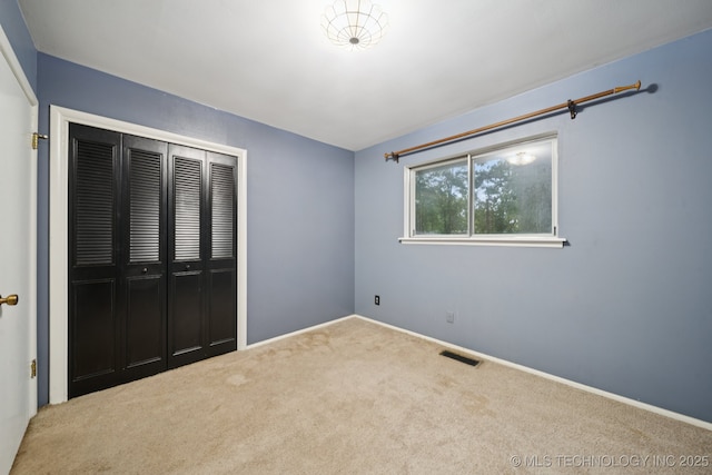 6922 E 16th St, Tulsa, OK 74112 - unfurnished bedroom with carpet and a closet