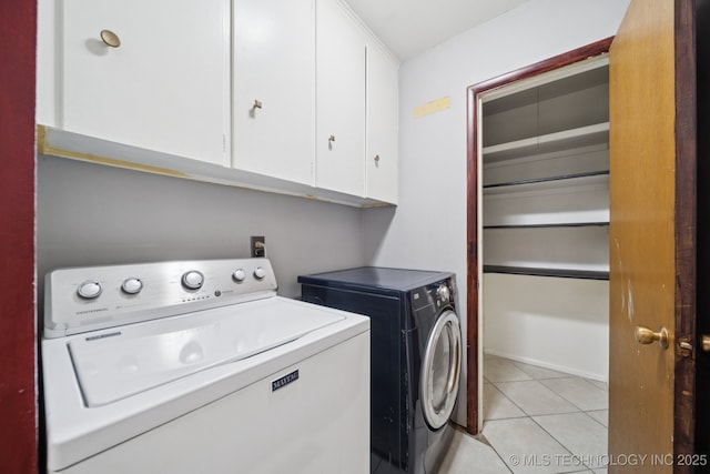 6922 E 16th St, Tulsa, OK 74112 - laundry area featuring cabinet space, washer and clothes dryer, and light tile patterned floors