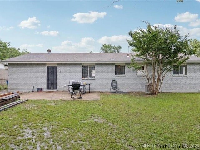 2346 S 118th E Ave, Tulsa, OK 74129 - back of house featuring a patio, a lawn, and brick siding