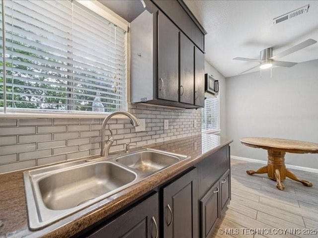 2346 S 118th E Ave, Tulsa, OK 74129 - kitchen featuring ceiling fan, decorative backsplash, light wood-style floors, and vaulted ceiling