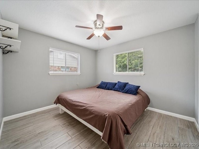 2346 S 118th E Ave, Tulsa, OK 74129 - bedroom with wood finished floors and ceiling fan