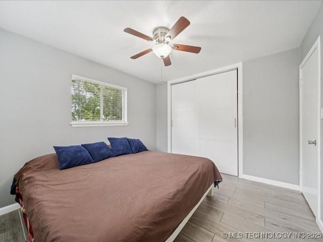 2346 S 118th E Ave, Tulsa, OK 74129 - bedroom featuring a closet, wood finished floors, and ceiling fan