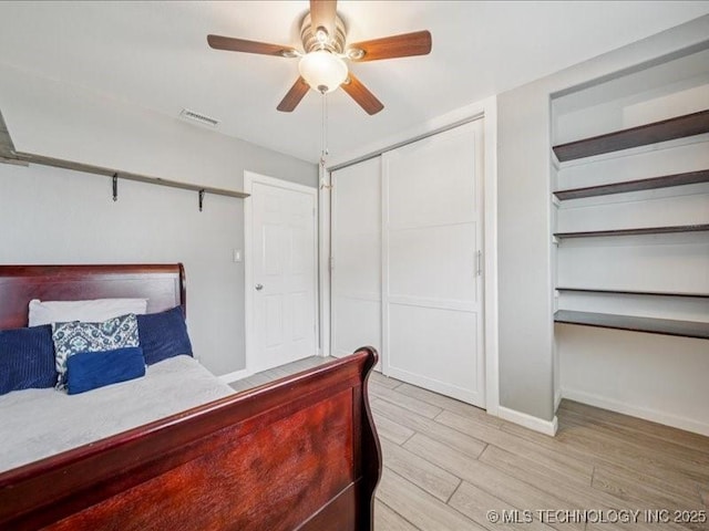 2346 S 118th E Ave, Tulsa, OK 74129 - bedroom featuring light wood finished floors, a closet, and a ceiling fan