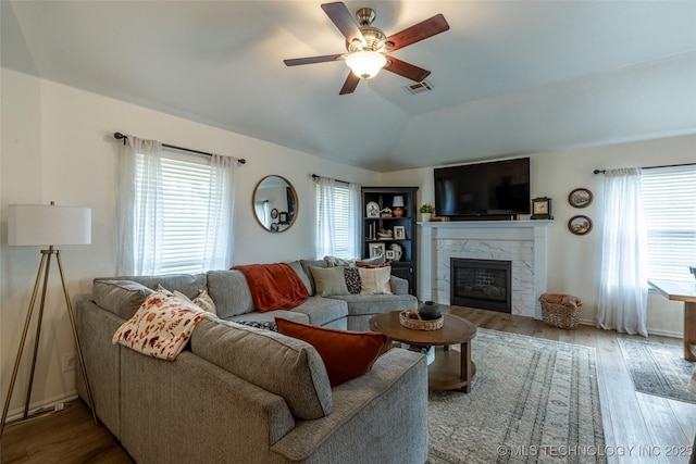 1113 S Spinnaker Dr, Oologah, OK 74053 - living room featuring ceiling fan, vaulted ceiling, a premium fireplace, and wood finished floors