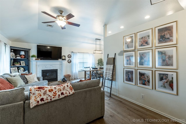 1113 S Spinnaker Dr, Oologah, OK 74053 - living room featuring dark wood-style floors, ceiling fan, a high end fireplace, vaulted ceiling, and recessed lighting