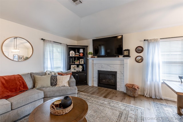 1113 S Spinnaker Dr, Oologah, OK 74053 - living area with wood finished floors, a high end fireplace, and lofted ceiling