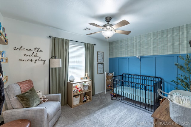 1113 S Spinnaker Dr, Oologah, OK 74053 - bedroom with a nursery area, carpet, wallpapered walls, a wainscoted wall, and ceiling fan