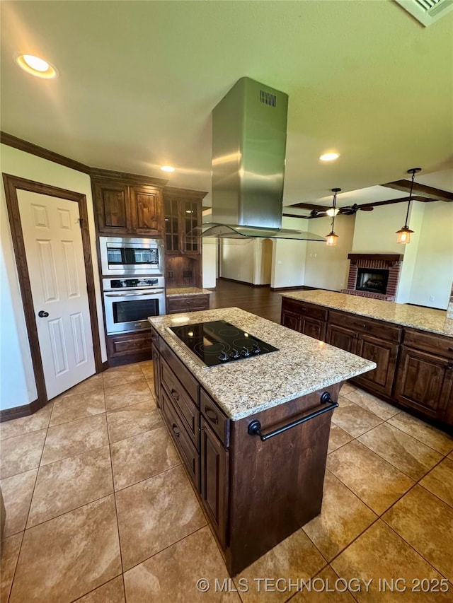5510 Cooper Ct, Bartlesville, OK 74006 - kitchen featuring appliances with stainless steel finishes, island range hood, dark brown cabinets, light tile patterned floors, and crown molding