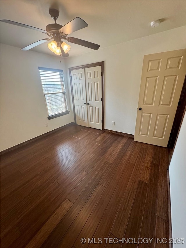 5510 Cooper Ct, Bartlesville, OK 74006 - unfurnished bedroom featuring dark wood-style flooring, a closet, and a ceiling fan
