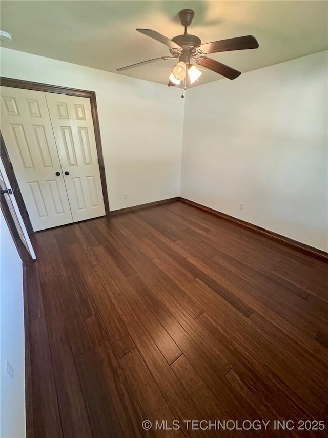 5510 Cooper Ct, Bartlesville, OK 74006 - unfurnished bedroom with dark wood-style floors, a closet, and a ceiling fan