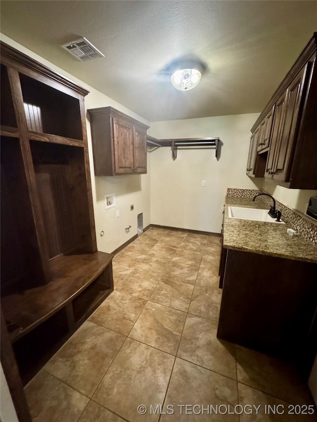 5510 Cooper Ct, Bartlesville, OK 74006 - laundry room with cabinet space, washer hookup, and light tile patterned flooring