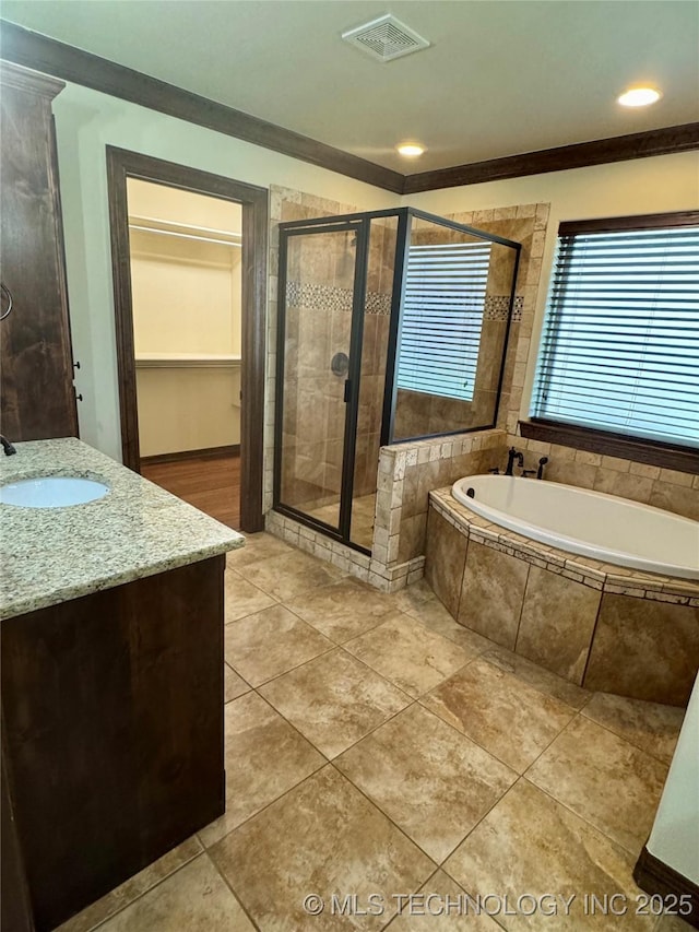5510 Cooper Ct, Bartlesville, OK 74006 - full bathroom featuring a shower stall, vanity, a garden tub, tile patterned flooring, and ornamental molding