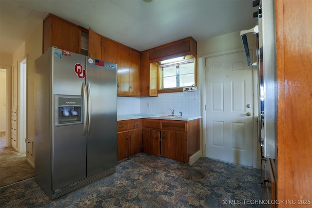 7266 S 58th W Ave, Tulsa, OK 74131 - kitchen featuring stainless steel refrigerator with ice dispenser, brown cabinets, and light countertops