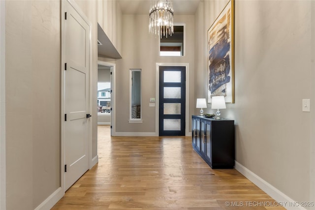4708 S Sequoia Ave, Broken Arrow, OK 74011 - entryway featuring light wood-style flooring, a chandelier, and a high ceiling