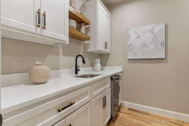4708 S Sequoia Ave, Broken Arrow, OK 74011 - kitchen featuring open shelves, light countertops, light wood finished floors, and white cabinets