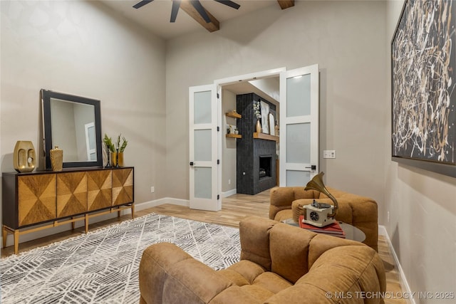 4708 S Sequoia Ave, Broken Arrow, OK 74011 - living area with a ceiling fan, wood finished floors, a fireplace, and a towering ceiling