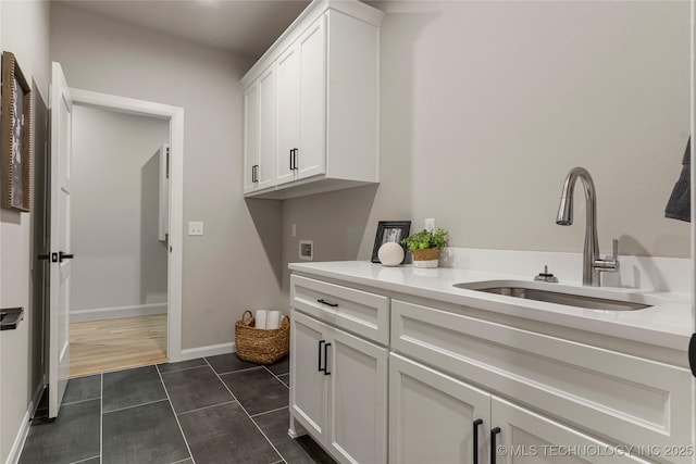 4708 S Sequoia Ave, Broken Arrow, OK 74011 - washroom featuring cabinet space, washer hookup, and dark tile patterned floors