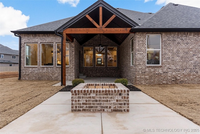 4708 S Sequoia Ave, Broken Arrow, OK 74011 - property entrance with brick siding, a patio, and roof with shingles