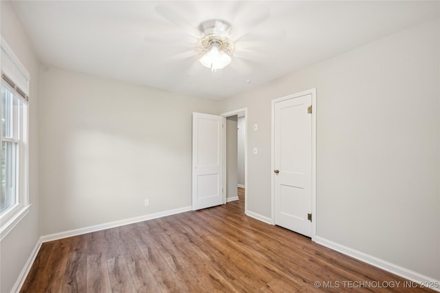 1013 N Main St, Sand Springs, OK 74063 - unfurnished bedroom featuring wood finished floors and ceiling fan