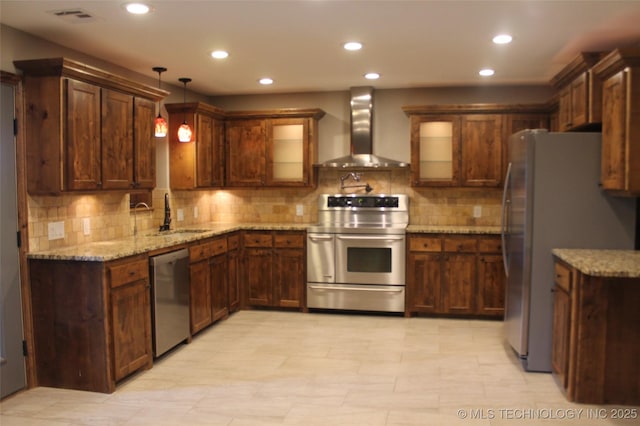 2148 E Wise Rd, Mcalester, OK 74501 - kitchen featuring appliances with stainless steel finishes, wall chimney exhaust hood, recessed lighting, decorative backsplash, and light stone countertops