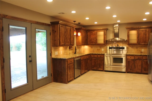 2148 E Wise Rd, Mcalester, OK 74501 - kitchen with stainless steel appliances, wall chimney range hood, french doors, recessed lighting, and light stone countertops